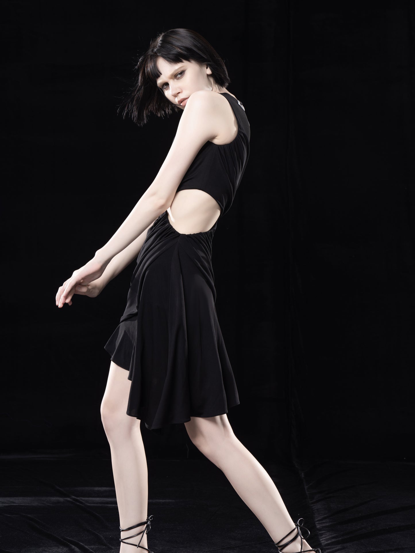 BLACK DRAPED DRESS WITH CUT-OUTS. ANND TIED DETAIL